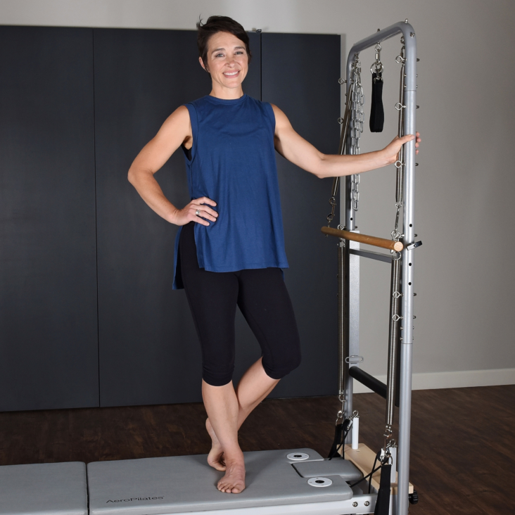 Woman with AeroPilates Standing Cadillac Workout