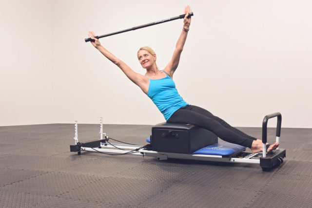 AeroPilates founder Marjolein Brugman uses the box and pole while on a reformer.