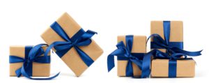 A set of presents wrapped in brown kraft paper and tied with blue bows.